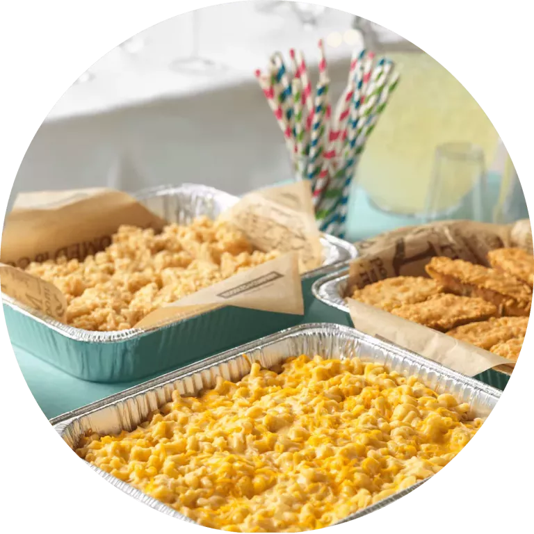 Catering pans of Creamy Cheddar Mac &amp; Cheese, Rice Crispies and Cheesy Garlic Bread