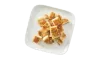 Portion of Parmesan Crusted Chicken Breast diced on a white plate